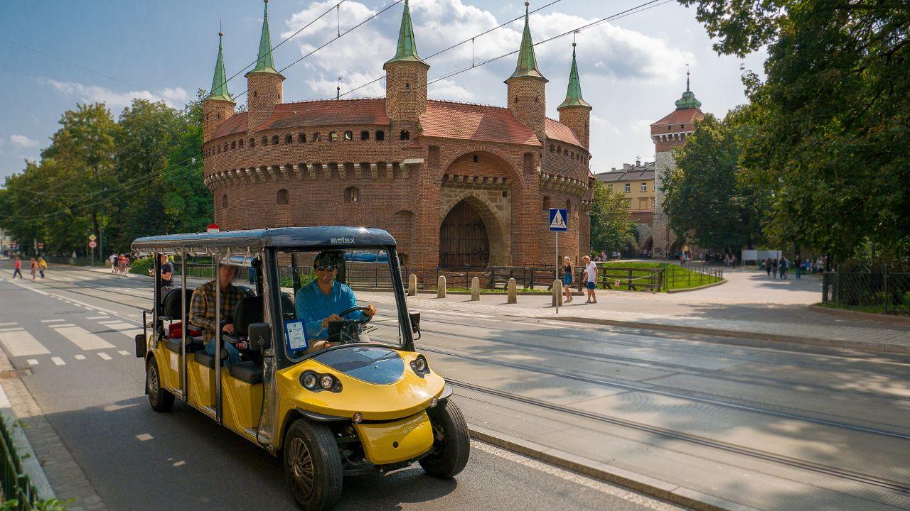 Tourists taking a comfortable and dry ride in an electric vehicle, exploring the sights of Krakow